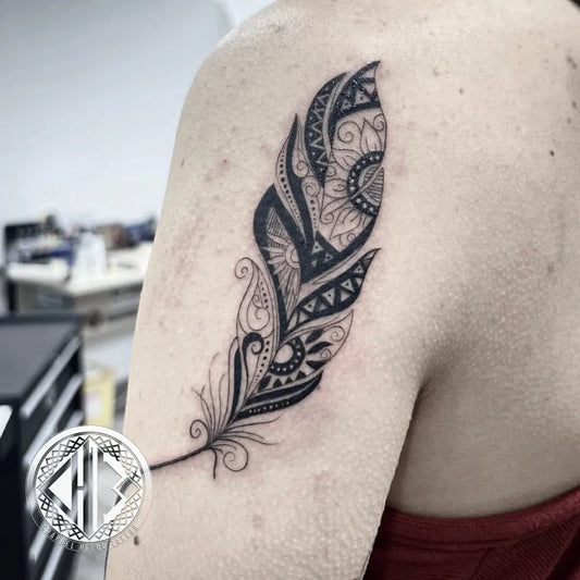 Medium Blackwork Feather Tattoo on Women Shoulder by @charbelheloutattoo