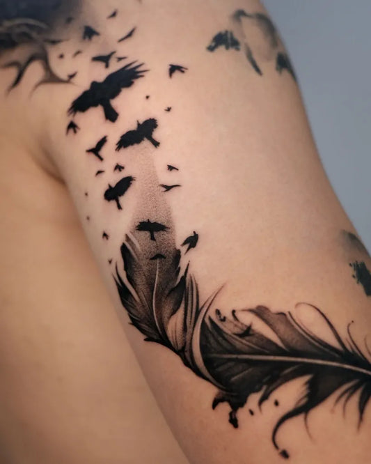Medium Blackwork Feather and Crows Tattoo on Men Arm by @tattooist_mate