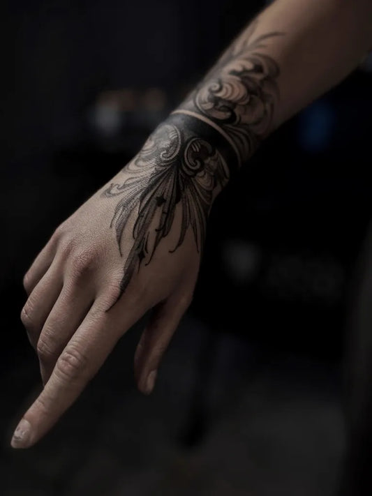 Medium Blackwork Floral Feather Band Tattoo on Women Wrist by @soy_mila_li