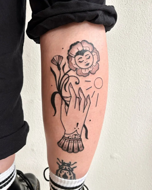 Medium Blackwork Flower Hand Tattoo on Women Calf by @done.by.denise