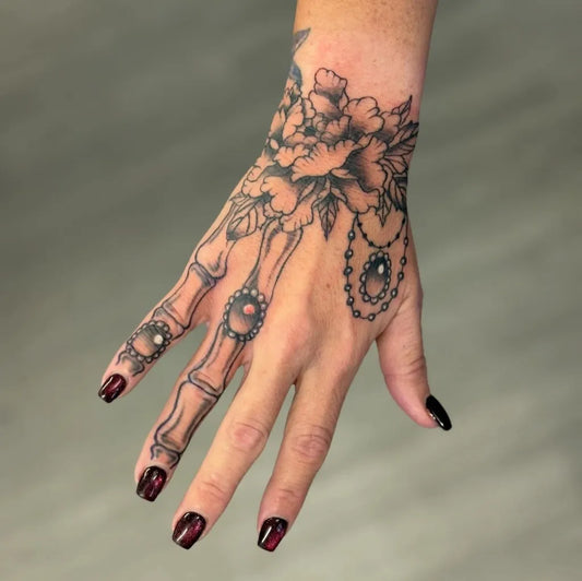 Medium Blackwork Flower Skeleton Tattoo on Women Wrist by @toners_tatts