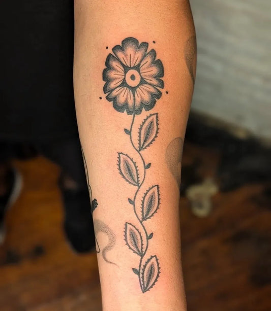 Medium Blackwork Flower Stem Nature Tattoo on Women Arm by @crownandfeathertattoo
