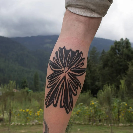 Medium Blackwork Flower Tattoo on Men Calf by @dreaminc_tattoos