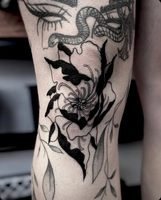 Medium Blackwork Flower and Snake Tattoo on Women Knee by @amberraboin.tattoos