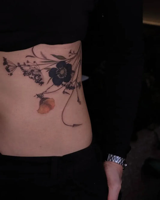 Medium Blackwork Flowers and Vines Tattoo on Women Rib by @czarnykot.tattoo