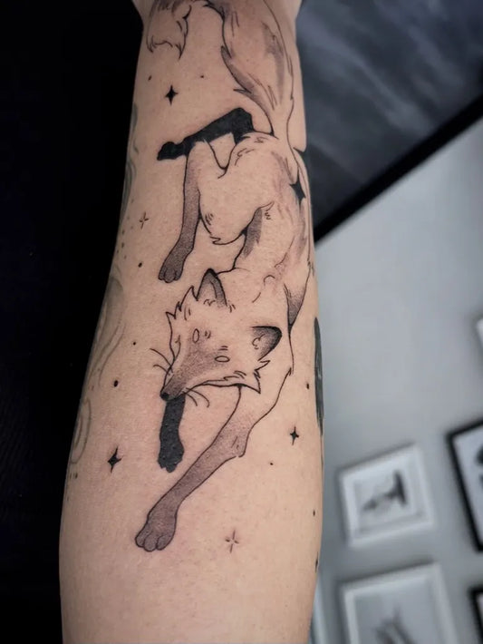 Medium Blackwork Fox with Stars Tattoo on Women Arm by @mastilnicatattoo