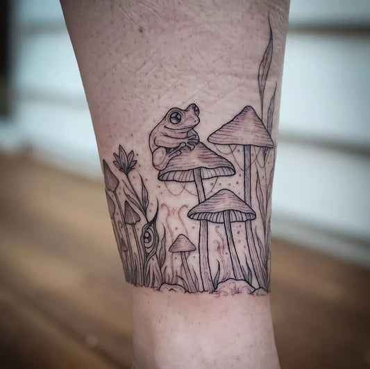 Medium Blackwork Frog Mushrooms on Women Leg Tattoo by @death.meadow.tattoo