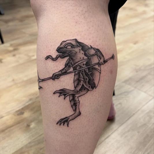 Medium Blackwork Frog Warrior Tattoo on Women Leg by @ash.tattoos