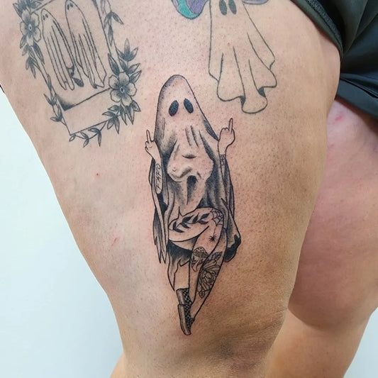 Medium Blackwork Ghost with Floral Frame Tattoo on Women Thigh by @notacooltattoo.sami