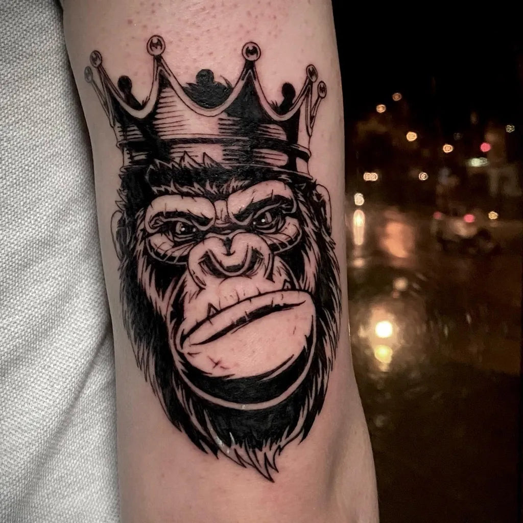 Medium Blackwork Gorilla Crown Tattoo on Men Arm by @numentattoo