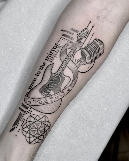 Medium Blackwork Guitar Microphone Ribbon Music Tattoo on Men Forearm by @primaiatattoo