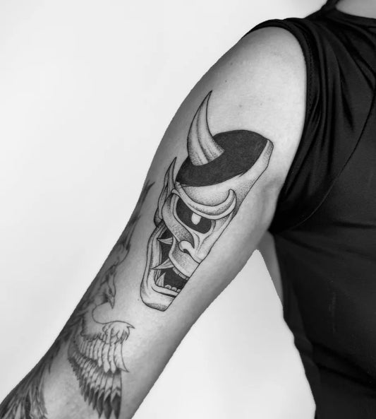 Medium Blackwork Half Oni Mask on Women Arm Tattoo by @tayco.tattoo