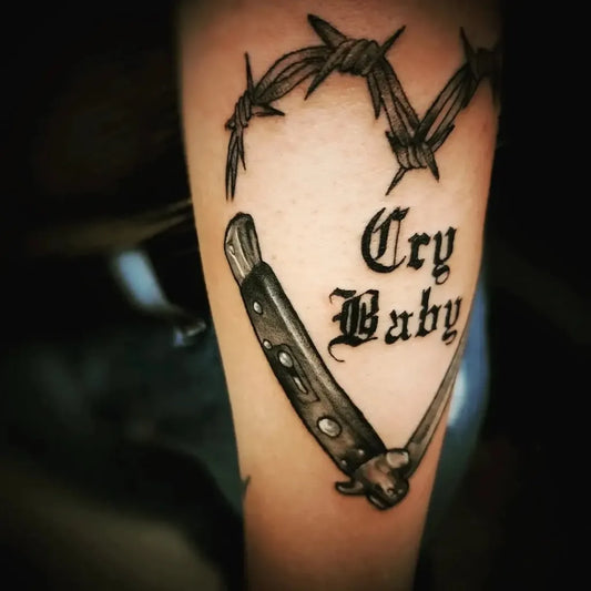 Medium Blackwork Heart Knife Tattoo on Women Arm by @lifetimetattoos