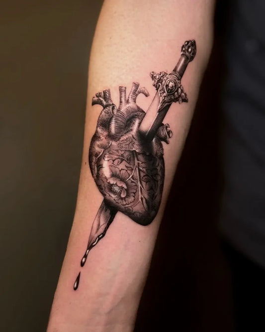 Medium Blackwork Heart pierced by @sword on men arm Tattoo by @jasonkeehntattoo