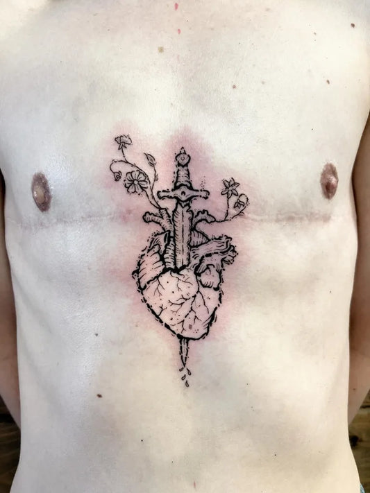 Medium Blackwork Heart pierced by @sword with vines on Men Chest Tattoo by @everguild.ink