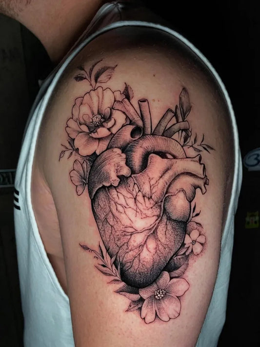 Medium Blackwork Heart with Flowers on Men Shoulder Tattoo by @adrianlamingtattoo