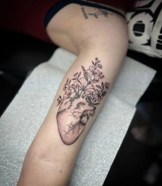 Medium Blackwork Heart with Flowers on Women Thigh Tattoo by @hausofsweetpoison