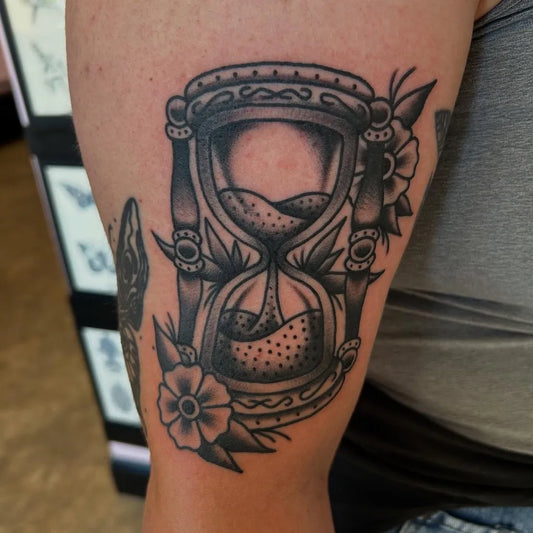 Medium Blackwork Hourglass and Flowers Tattoo on Women Arm by @raygunxtats