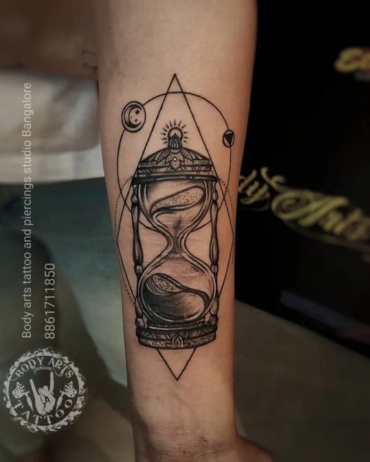 Medium Blackwork Hourglass and Geometric Symbols Tattoo on Men Forearm by @bodyarts_blr