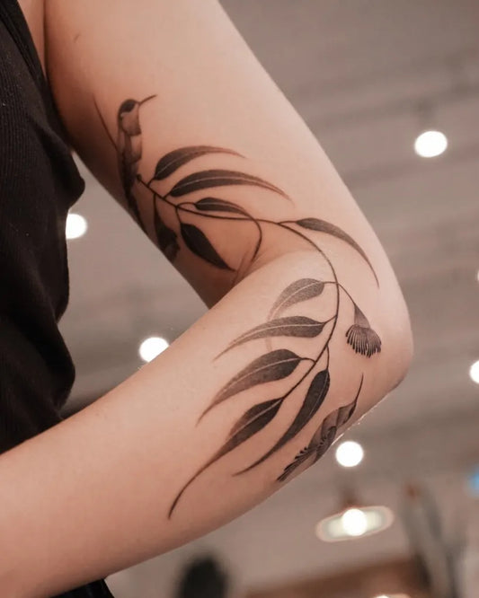 Medium Blackwork Hummingbird Eucalyptus on Women Arm Tattoo by @solyn_tattooist