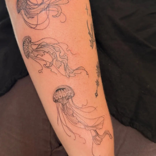 Medium Blackwork Jellyfish Tattoo on Women Arm by @carpediam.ink