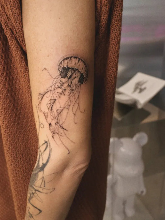 Medium Blackwork Jellyfish Tattoo on Women Arm by @zsofi.csepai