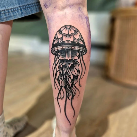 Medium Blackwork Jellyfish Tattoo on Women Leg by @before_the_mast