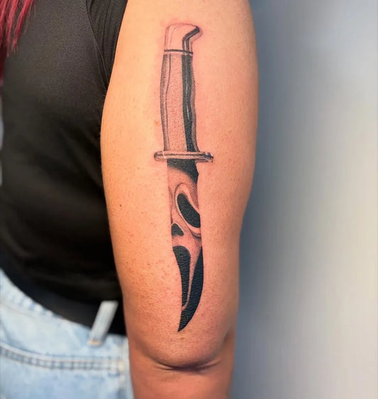 Medium Blackwork Knife Horror Tattoo on Women Arm by @rhysedmundstattoo