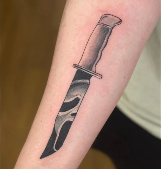 Medium Blackwork Knife Scream Horror Tattoo on Men Arm by @zoe.eli.tattoo