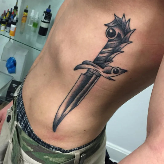 Medium Blackwork Knife Tattoo on Men Rib by @sleiborg.tattoo