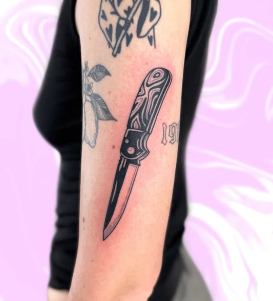 Medium Blackwork Knife Tattoo on Women Arm by @racotattoo