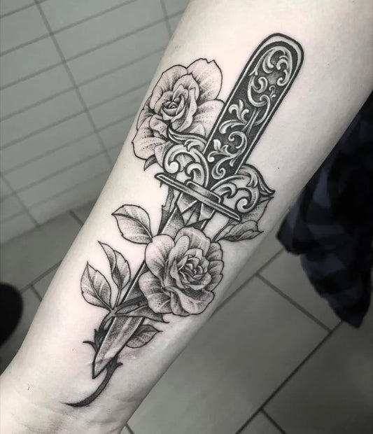 Medium Blackwork Knife and Roses Tattoo on Women Arm by @mj1tattoo