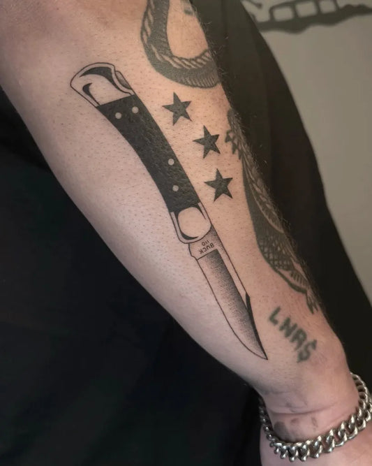 Medium Blackwork Knife and Stars Tattoo on Men Arm by @whiteghoststudio