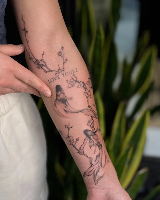 Medium Blackwork Koi Fish and Cherry Blossoms Spiritual Tattoo on Women Arm by @metaphysicalink
