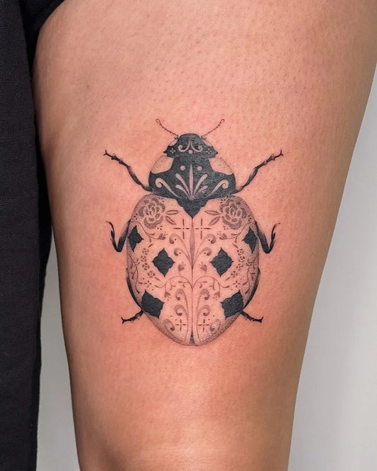 Medium Blackwork Ladybug Tattoo on Women Thigh by @gaiahart