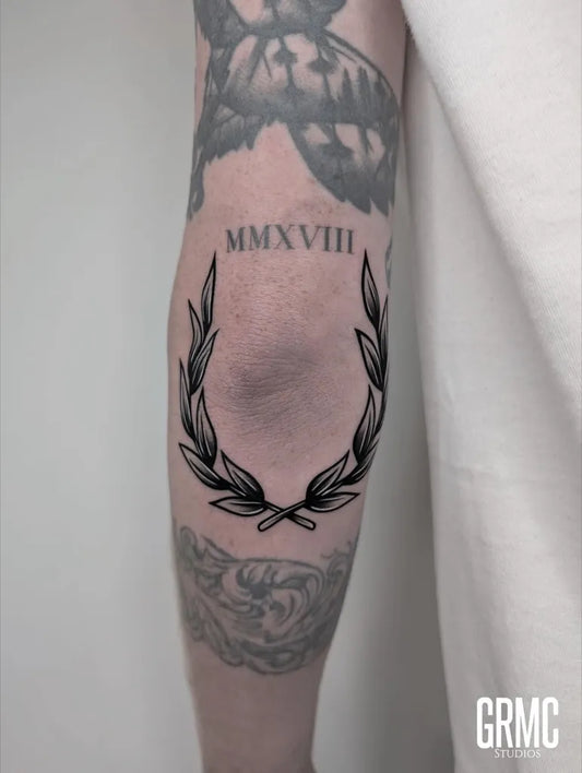 Medium Blackwork Laurel Wreath Tattoo on Men Arm by @grmcstudios