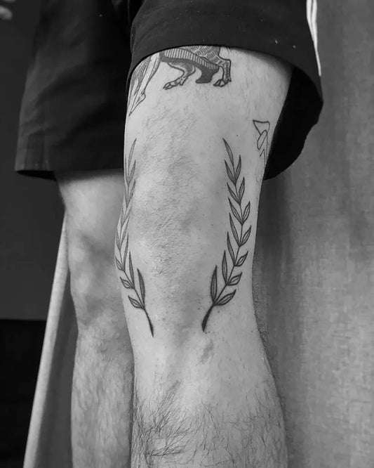 Medium Blackwork Laurel Wreath Tattoo on Men Knee by @damagedonetattoo