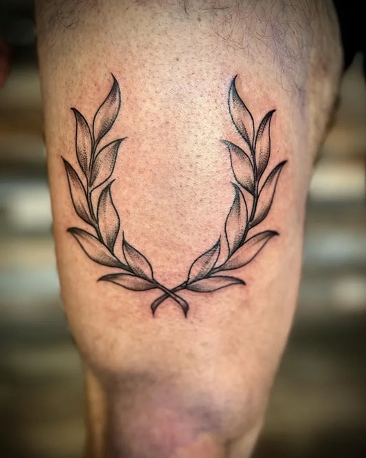 Medium Blackwork Laurel Wreath Tattoo on Men Upper Arm by @voodooladytattoos
