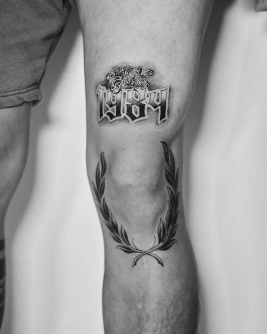 Medium Blackwork Laurel Wreath and Old English Text Tattoo on Men Knee by @kayneinklab