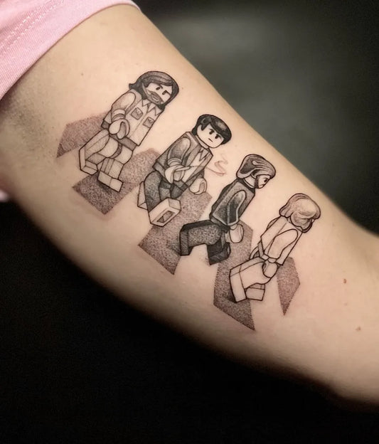 Medium Blackwork Lego Beatles Music Tattoo on Women Arm by @lucywebstertattoo