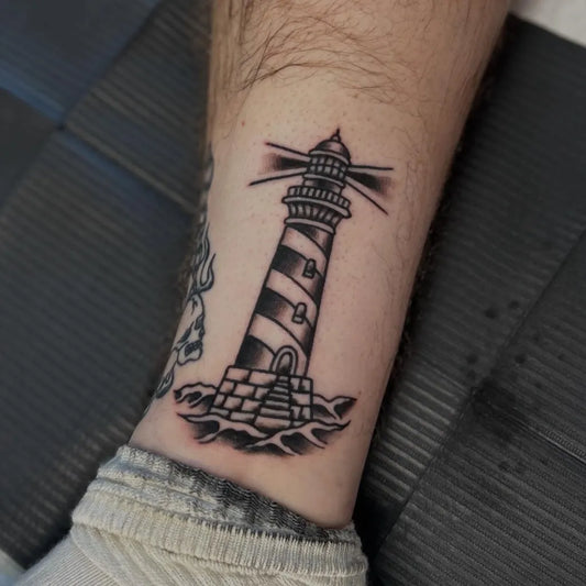 Medium Blackwork Lighthouse Tattoo on Men Leg by @gibbs.tattoo