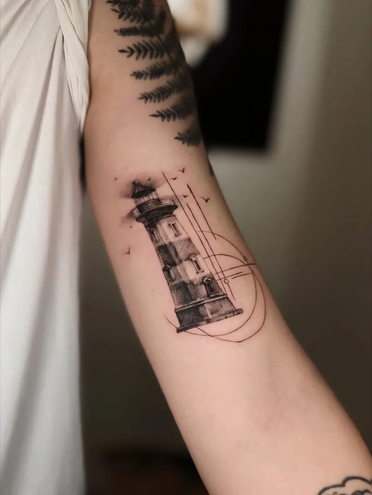 Medium Blackwork Lighthouse and Birds Tattoo on Women Arm by @inkcrafttattoomalaysia