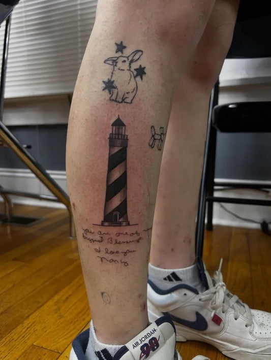 Medium Blackwork Lighthouse and Bunny Tattoo on Women Leg by @tattoos.by.aj_
