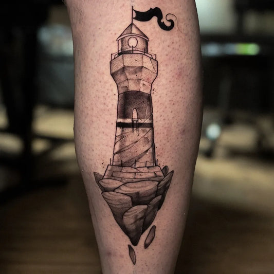 Medium Blackwork Lighthouse on Floating Rock Tattoo on Men Leg by @artcraft_tattoo