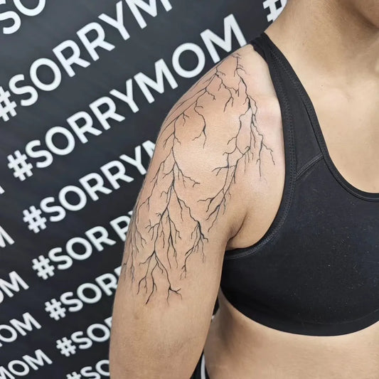 Medium Blackwork Lightning Bolt Tattoo on Women Shoulder by @larissajadetattoo