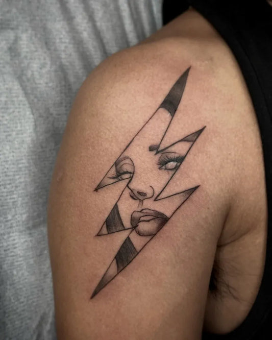 Medium Blackwork Lightning Bolt with Marilyn Monroe Face Tattoo on Women Shoulder by @charlotparis_inks