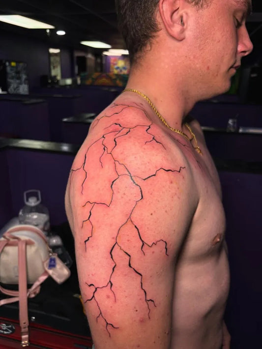 Medium Blackwork Lightning Bolts Tattoo on Men Shoulder by @tats.by.vaehh