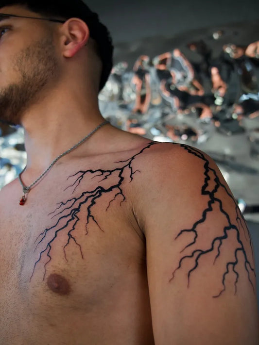 Medium Blackwork Lightning Bolts Tattoo on Men Shoulder by @tattooschmid