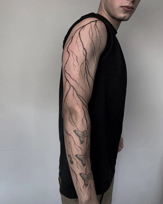 Medium Blackwork Lightning Bolts and Butterflies Tattoo on Men Arm by @melwest.tattoos