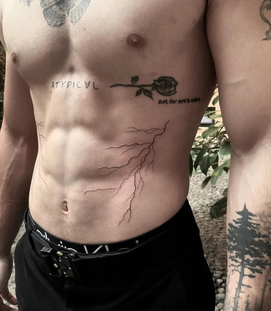 Medium Blackwork Lightning Rose Text Tattoo on Men Side by @sailorstattoomilanobovisa